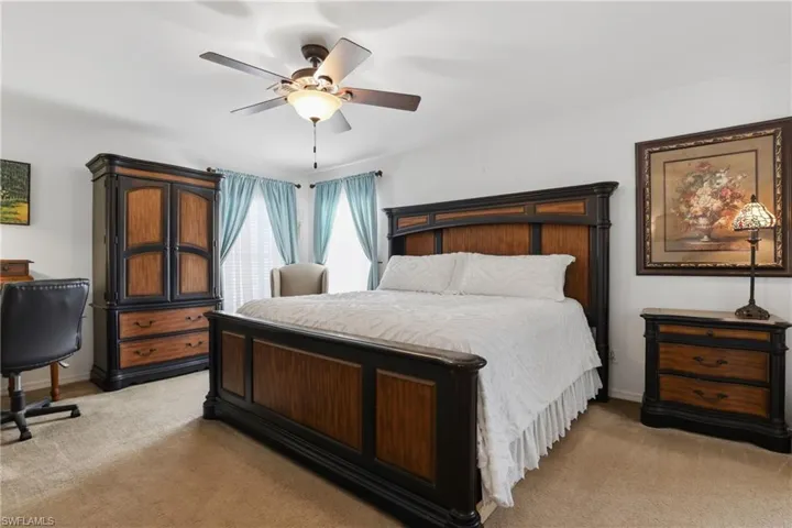 Bedroom featuring light colored carpet and ceiling fan