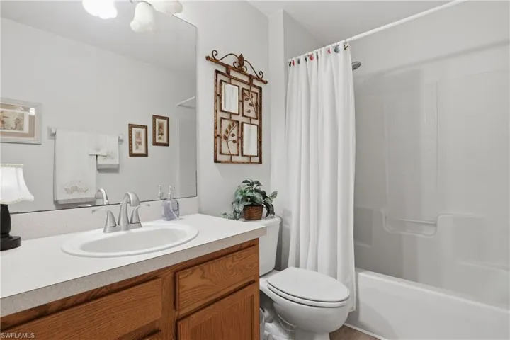 Full bath with vanity and shower / bath combination with curtain