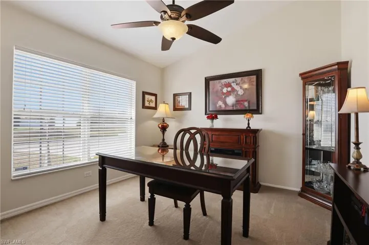 Office featuring light carpet, vaulted ceiling, and ceiling fan
