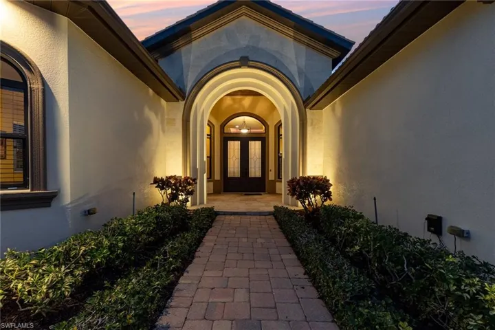 Exterior entry at dusk with french doors