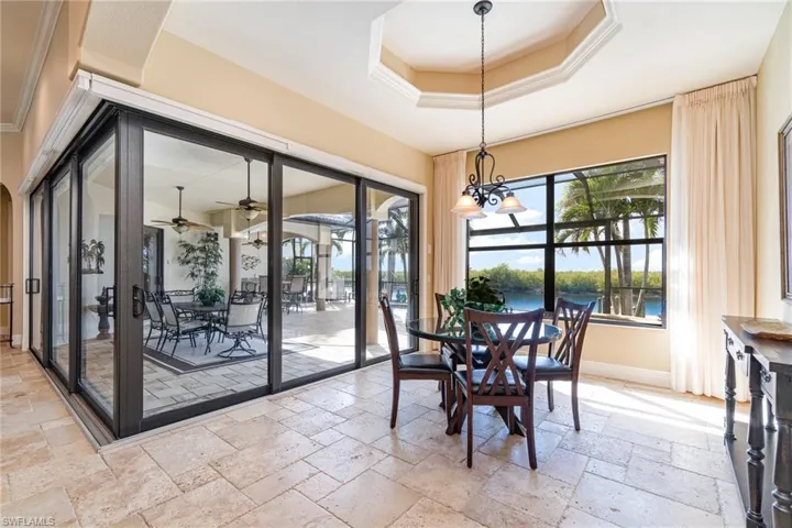 Morning room featuring a water view and a tray ceiling