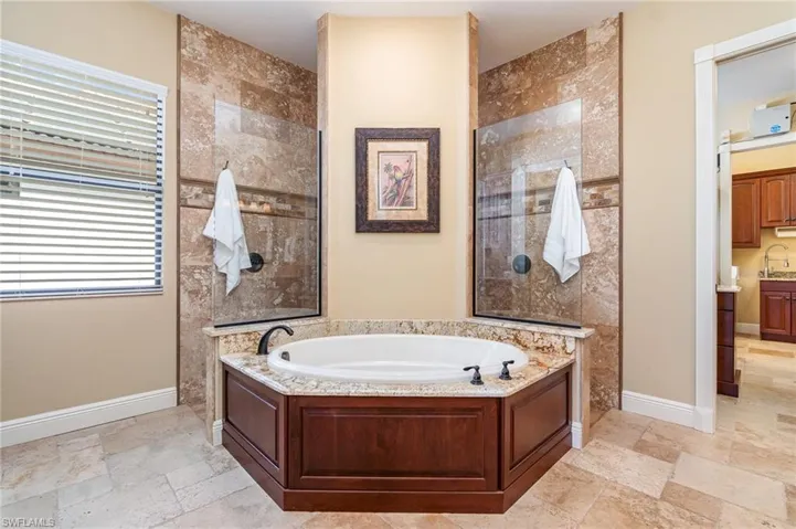Bathroom featuring vanity and separate shower and tub
