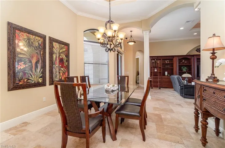 Dining room featuring crown molding, and a chandelier