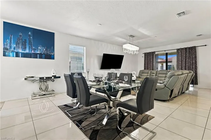 White tile flooring, white walls, and a rectangular chandelier