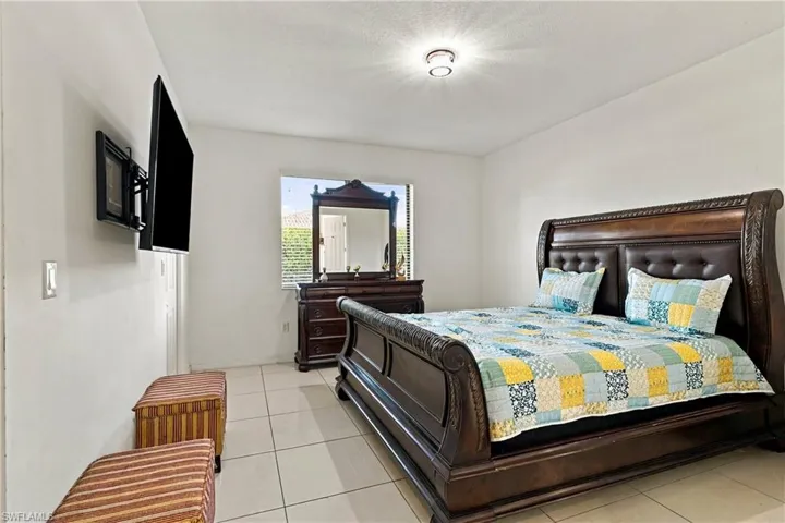 Recessed ceiling light fixture, tile flooring, and window with horizontal blinds