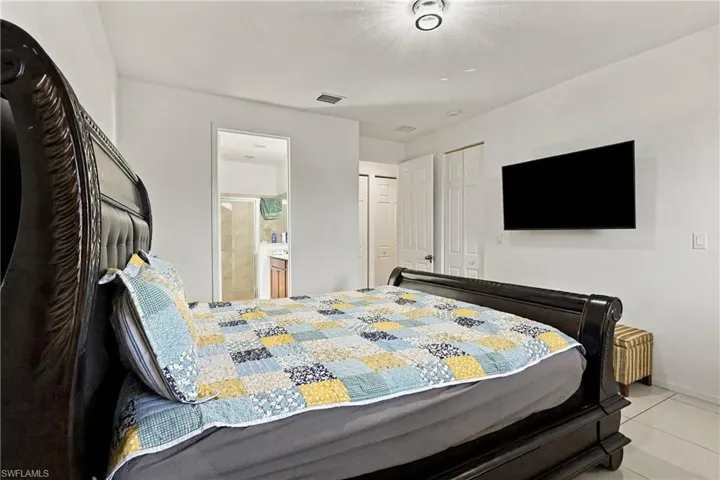 Recessed lighting, wall-mounted television, and tile flooring