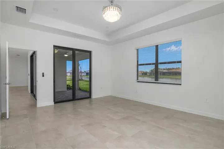 Primary bedroom includes sliding doors to the outdoor lanai space providing plenty of natural light.