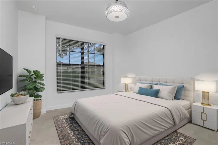 Spacious guest bedroom at the front of the home includes chandelier/ceiling fan and plenty of natural light. (furniture digitally added)
