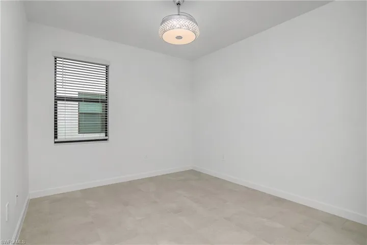View of spare roomSpacious guest bedroom with ensuite bath includes chandelier/ceiling fan and plenty of natural light.