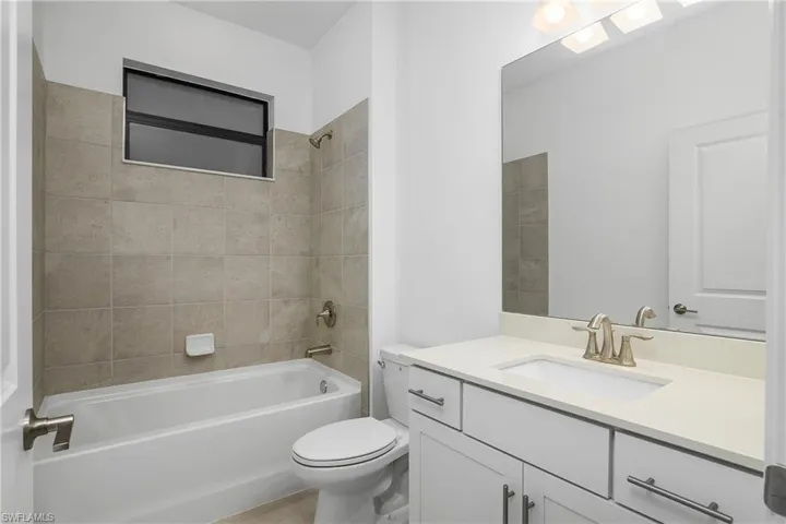 Guest Bathroom features tub/shower and large vanity.
