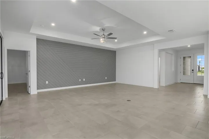 Spacious great room with feature wall, additional recessed lighting and lighted ceiling fan provide plenty of light.