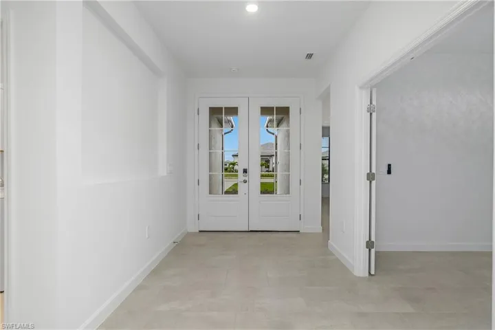 Open and inviting entryway with double, glass-paned doors.