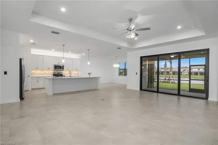 Open floor plan featuring great room, kitchen, dining room, with lanai.
