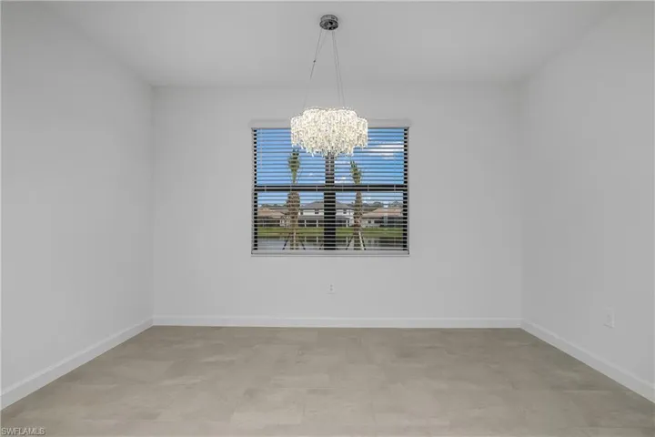 Family dining space is located just off the kitchen and features designer lighting and plenty of natural light.