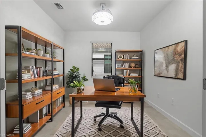 Versatile Den with double french doors is perfect for a home office or additional TV room. (Furniture digitally added.)
