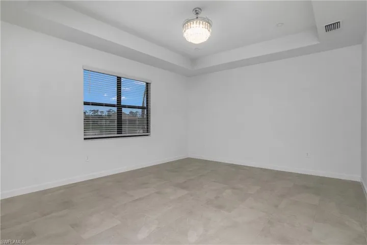 Primary bedroom is spacious and includes additional recessed lighting, chandelier/ceiling fan, and spa-like bath.