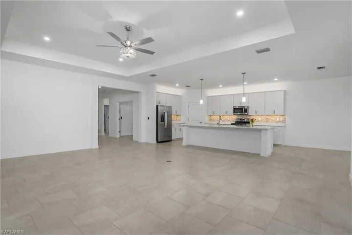 Open floor plan featuring great room, kitchen, dining room, with lanai.
