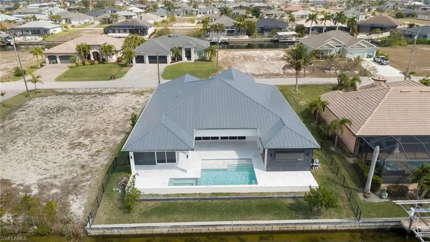Aerial perspective of suburban area featuring a pool