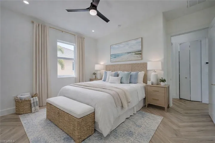 Bedroom featuring parquet floors, ceiling fan, and recessed lighting