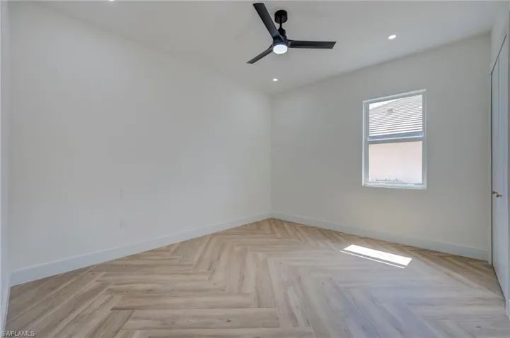 Unfurnished room featuring parquet floors, recessed lighting, and ceiling fan