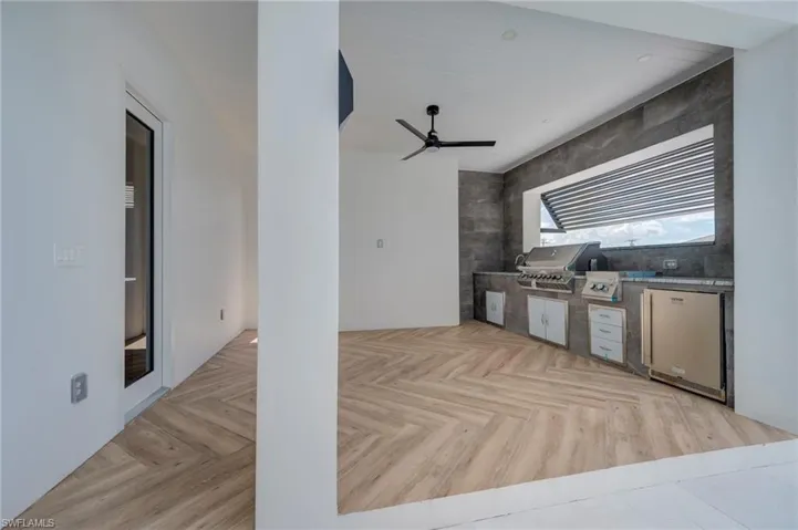 View of patio with an outdoor kitchen and a ceiling fan