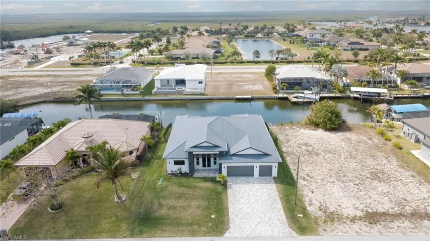 Aerial view of residential area featuring a large body of water