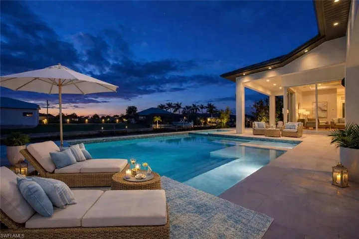 Swimming pool featuring outdoor furniture and a patio area