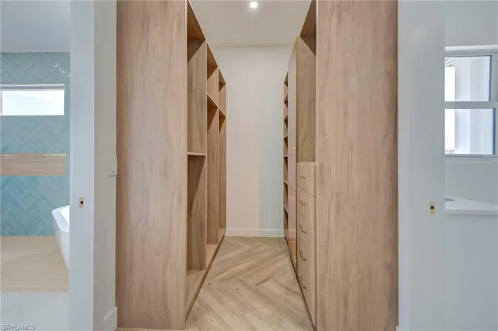 Walk in closet featuring parquet flooring