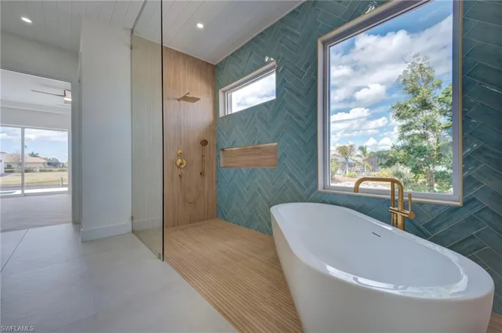 Bathroom featuring a soaking tub, a walk in shower, and recessed lighting