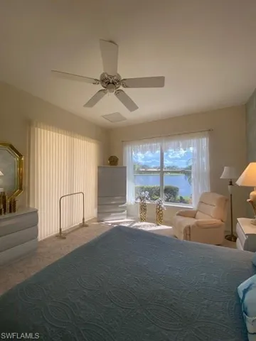 Carpeted bedroom with ceiling fan