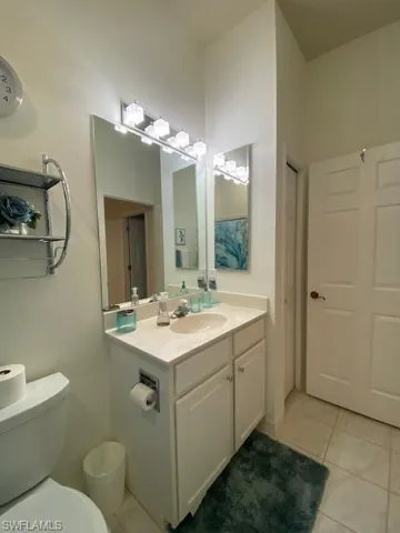 Bathroom featuring vanity, toilet, and tile patterned flooring