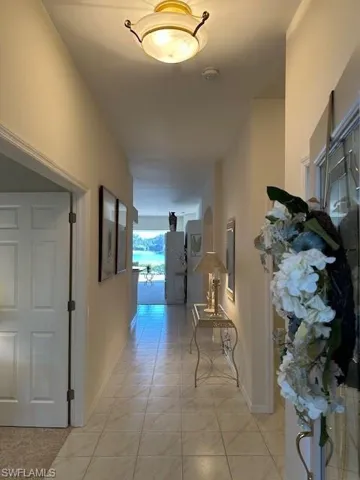 Hallway featuring light tile patterned floors