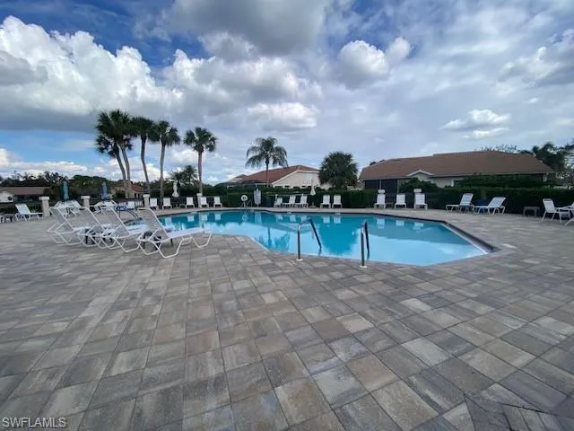 View of community swimming pool with a patio