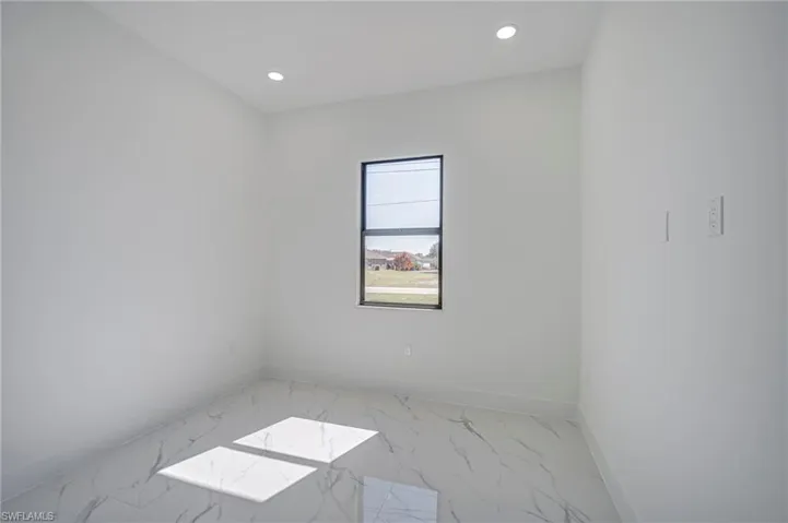 Unfurnished room with recessed lighting and light marble finish flooring