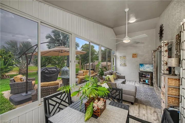 Enclosed patio with full-length windows and wood-finish flooring