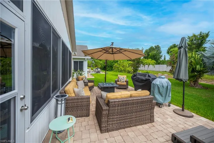 Expansive paver patio offering direct access to the interior via a screened lanai