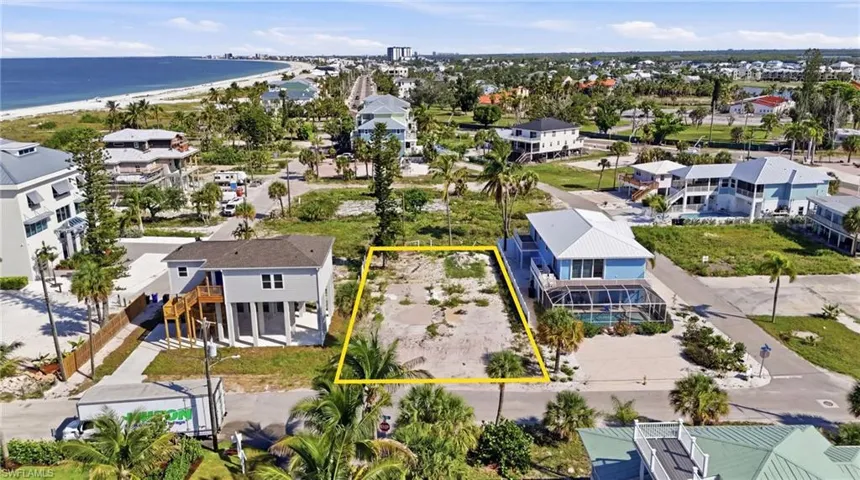 Vacant lot featuring existing vegetation and surrounding residential properties