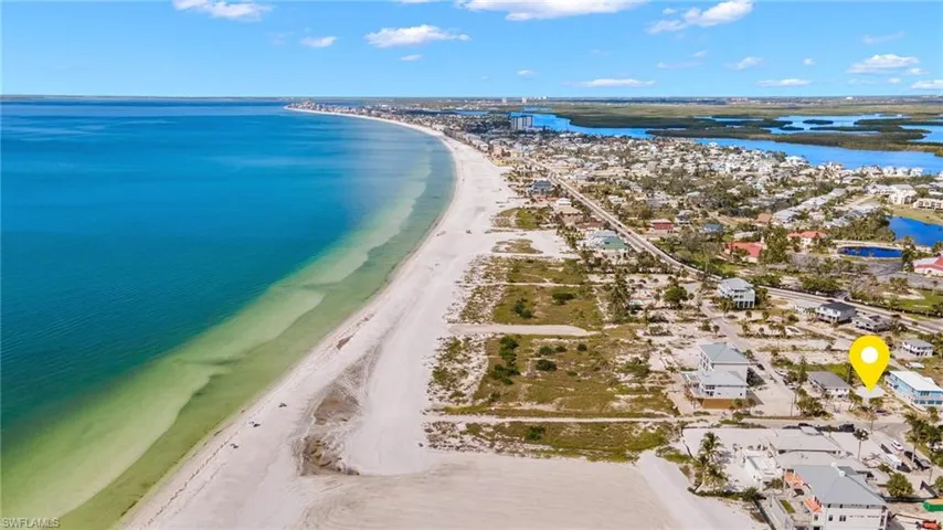 Aerial view featuring a beach view and a water viewVirtually enhanced