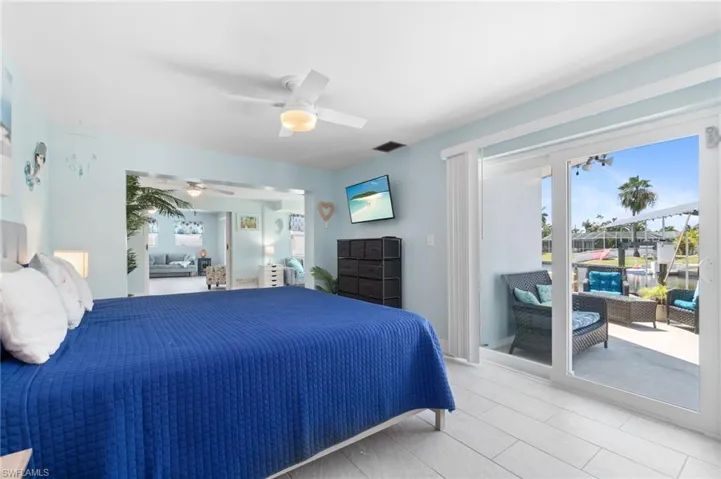 Bedroom featuring ceiling fan, access to outside, and light tile floors