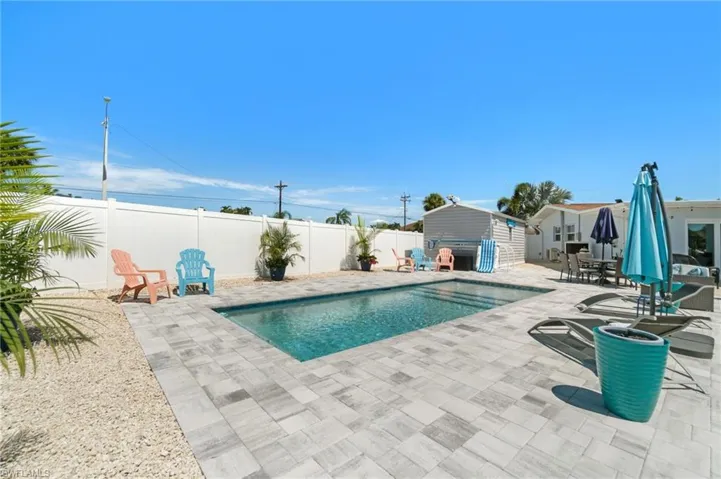 View of pool with a patio and an outdoor structure