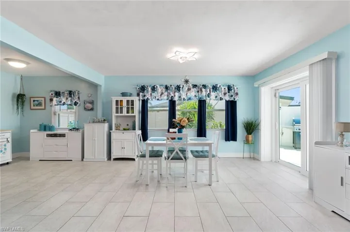 Dining space with light tile flooring and a wealth of natural light