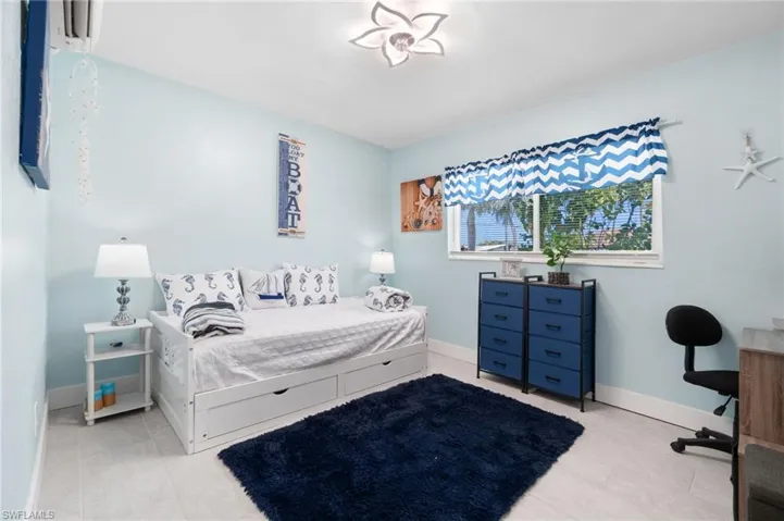 Bedroom featuring light tile floors