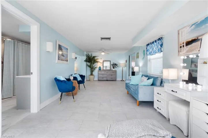 Tiled sitting area featuring ceiling fan