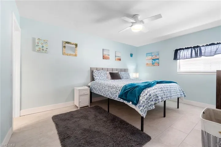 Tiled bedroom with ceiling fan