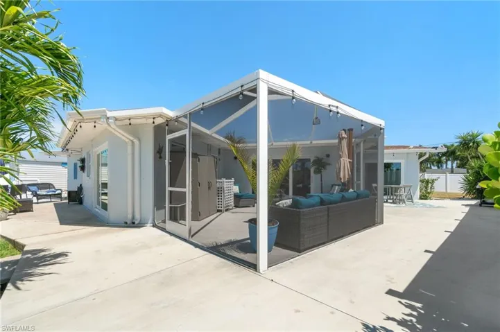 Rear view of property featuring an outdoor living space and a patio