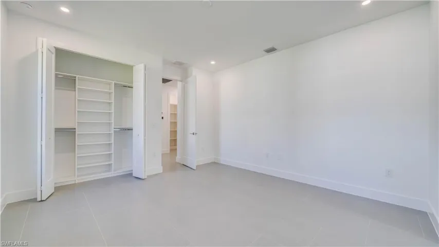Cabana bedroom closet with custom built-in shelving system.