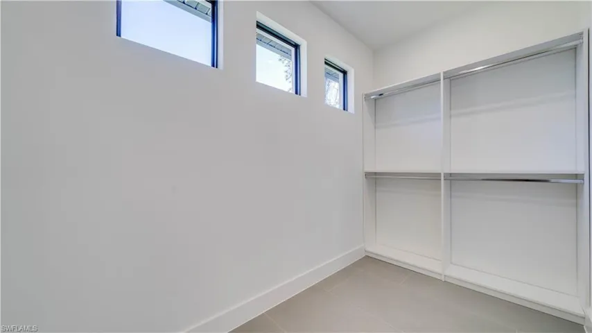 Large double closet with built-in closet shelving system.