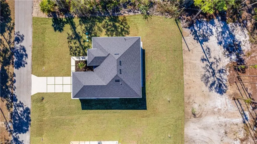Large half-acre yard all around the home. The back extends past the sandy area into the trees!