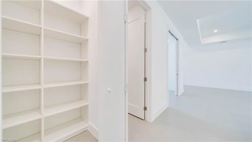 Large pantry with built in shelving system.