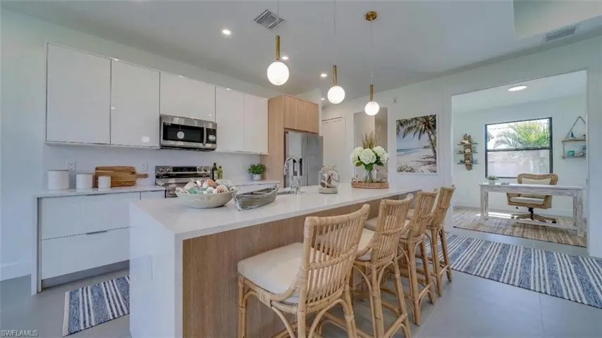 Virtually staged kitchen and den.